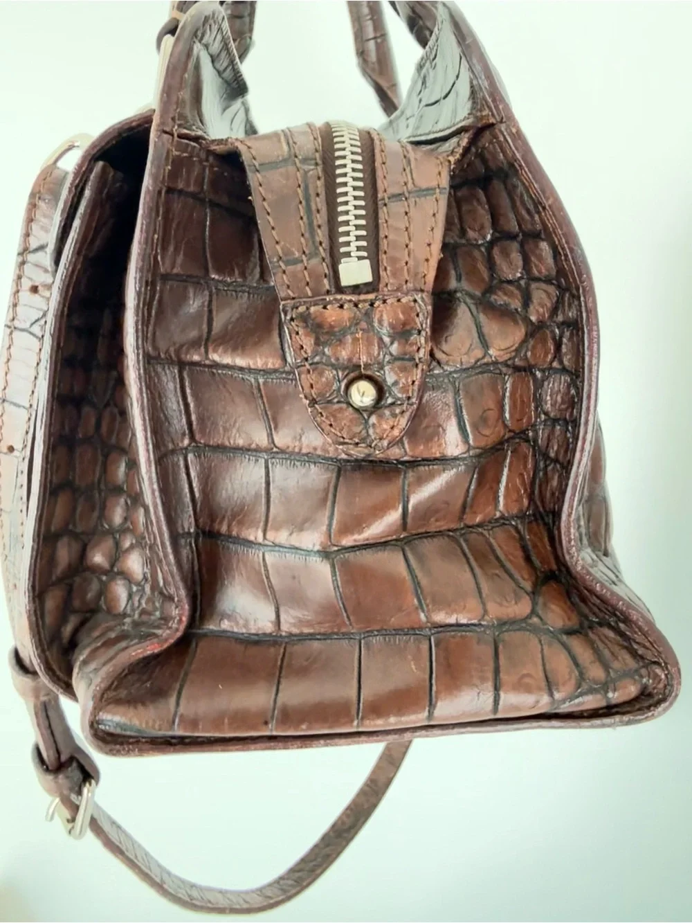 Dooney & Bourke, crafted from rich brown crocodile-embossed leather